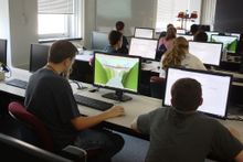Students looking at monitors from the 2013 Summer Camp